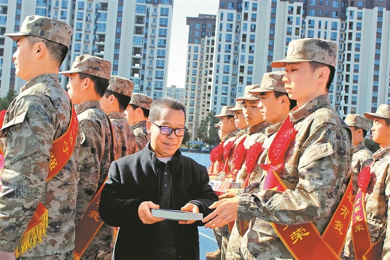 華中強向入伍新兵贈送《侵華日軍的滑鐵盧——西峽口抗戰紀實》一書。馬春歌 攝
