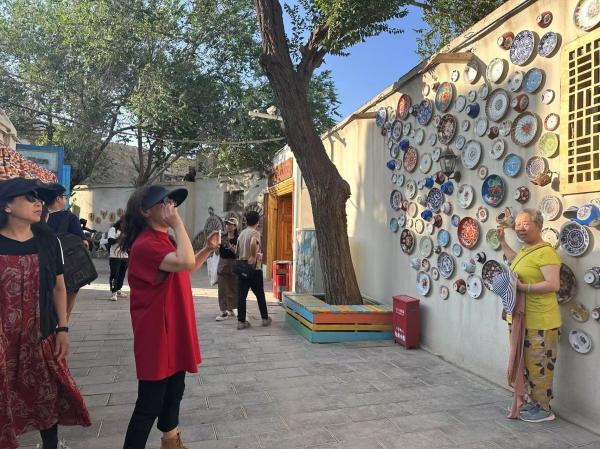 龟兹小巷内,游客排队打卡。