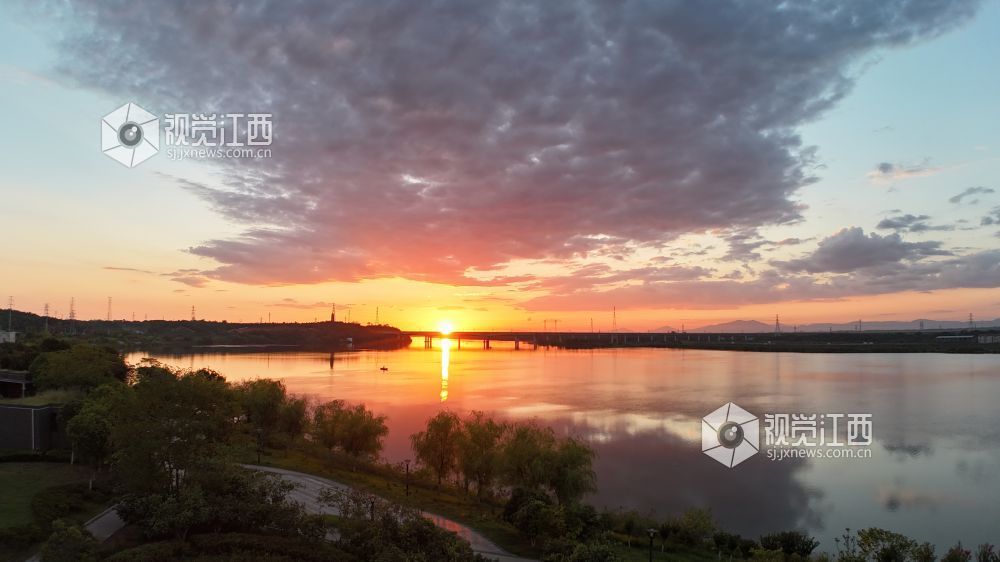 8月17日清晨，江西省吉安市泰和县城的赣江河畔，一轮红日冉冉升起，朝霞漫天，万丈光芒下的蓝天白云、大地、河流交相辉映，绚烂壮美。