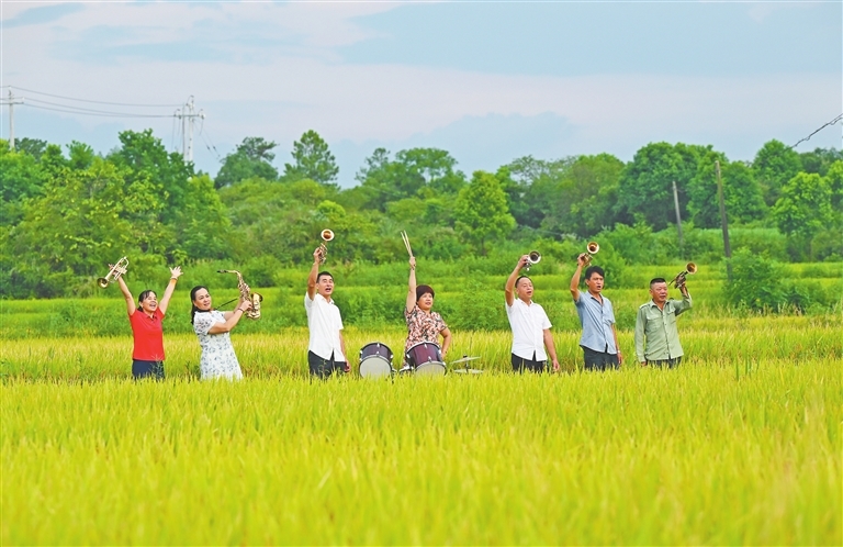 7月29日，吉安縣固江鎮(zhèn)東風(fēng)村，“稻香樂(lè)隊(duì)”的隊(duì)員們?cè)诘咎镏信啪殻硎芤魳?lè)帶來(lái)的樂(lè)趣。
