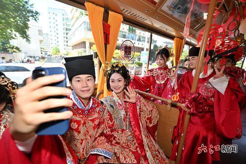 新人們穿著傳統婚服，乘坐“鐺鐺車”參加婚禮。江西日報全媒體記者王蘊蓉攝