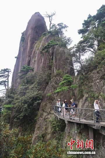 8月30日,江西上饶三清山,游客在高空栈道上观光拍照。中新社记者 刘力鑫 摄