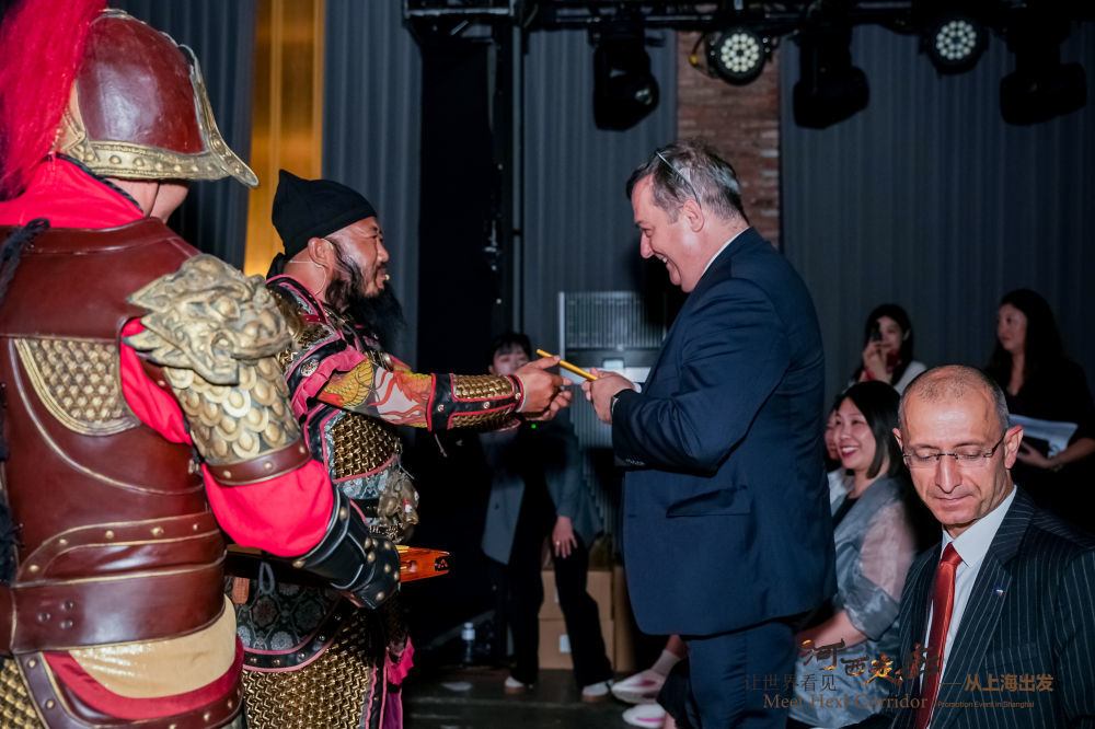 在活动现场,来自嘉峪关的文旅工作人员与嘉宾互动。新华社发