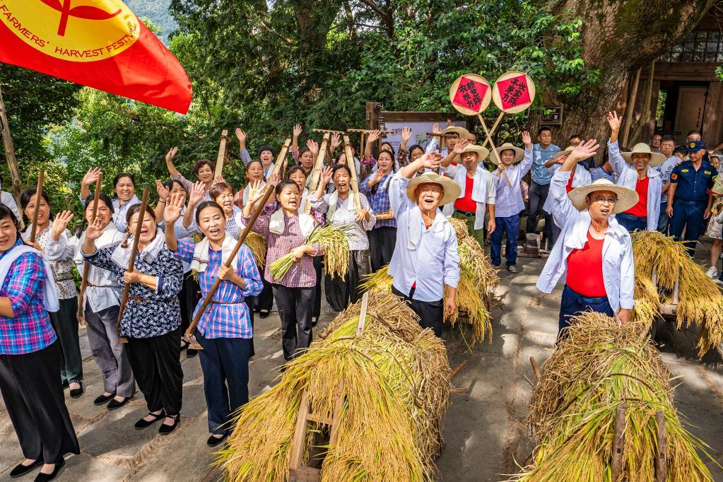 村民们欢欢喜喜庆丰收。 新华网发