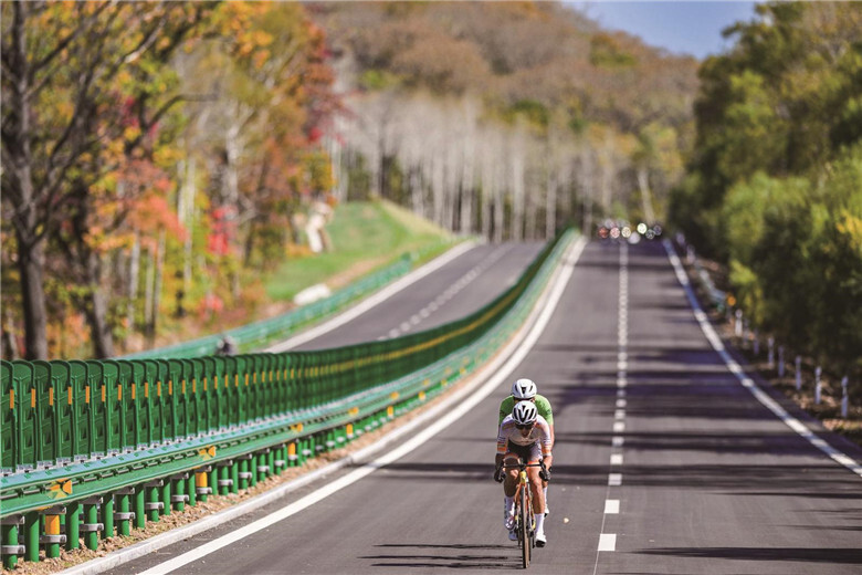 9月27日,参加第八届环长白山森林自行车赛的选手竞速骑行。王智超 摄