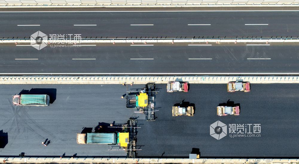 2025年10月10日,由中铁十八局集团有限公司承建的樟吉高速公路改扩建工程A2标江西省吉安市峡江县戈坪乡施工现场,工人在进行沥青摊铺作业。