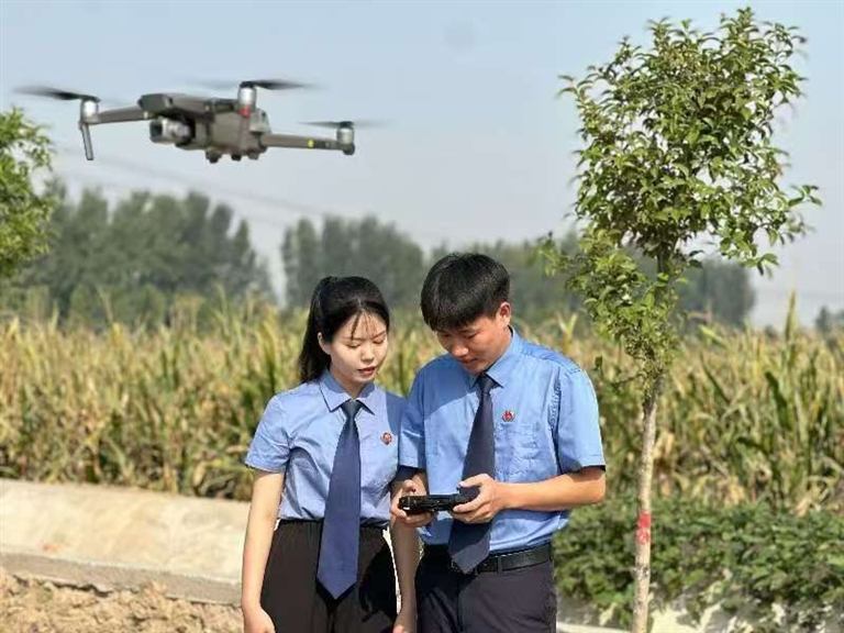 新乡检察机关技术信息部门检察官在河岸边操作无人机进行巡查。 孙芳 摄