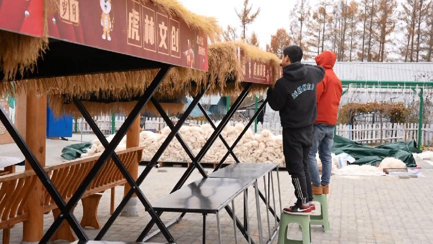 (工作人员进行年货大集摊位布置)