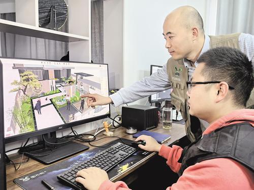 10月29日，承德图布斯科技集团有限公司技术人员正在调试设计图。 本报记者 陈宝云摄