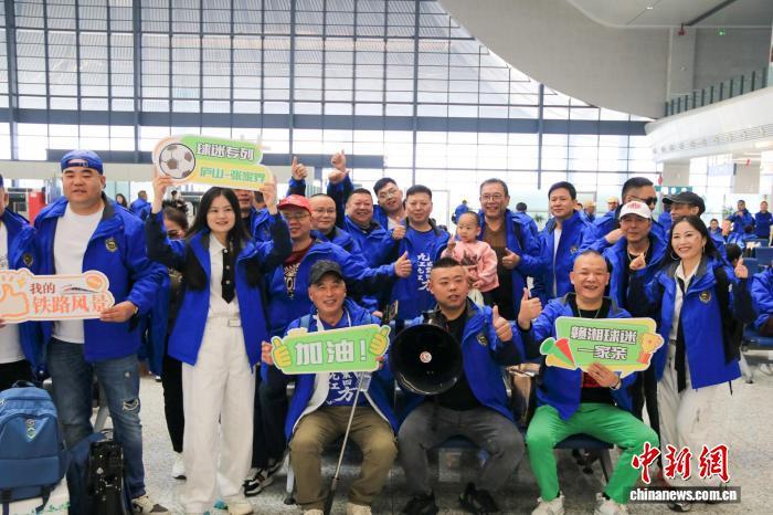 图为11月15日,江西庐山站,球迷手举应援牌在庐山站候车室合影。利嘉圆 摄