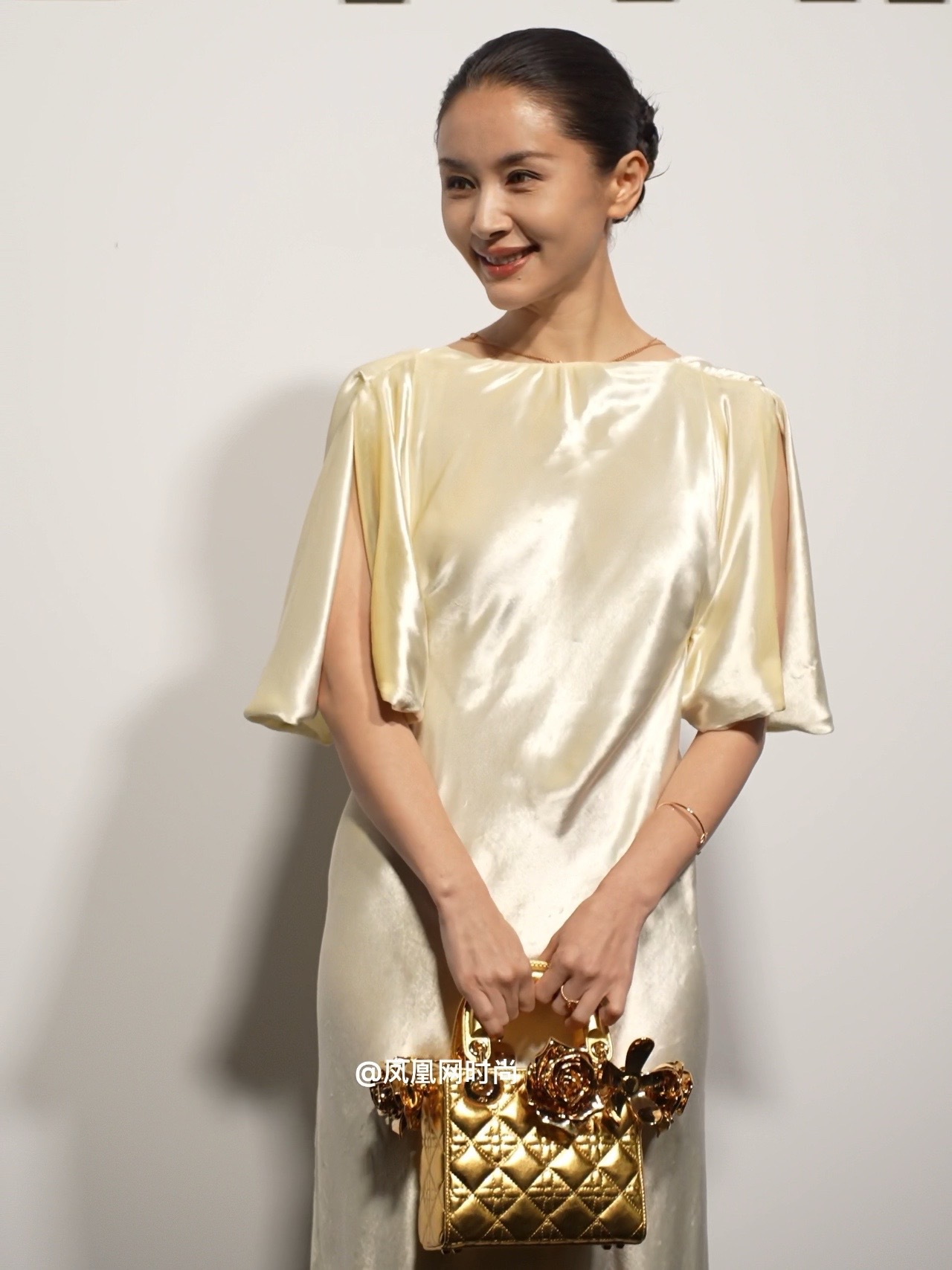 王子文骨相绝了 今天#Dior 活动红毯上的#王子文，一袭香槟色缎面长裙，仿佛自带柔光滤镜。灵动的飞袖设计超仙，搭配金色手包，高级感瞬间拉满！在 DIOR LADY ART 的现场，美得像从画里走
