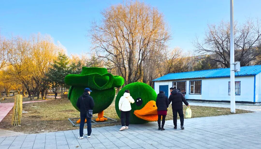 市民在近距离观看园内即将安装的装饰玩偶。