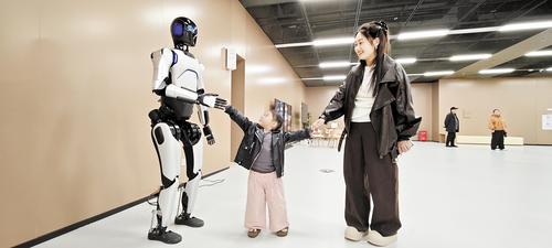 近日，雄安图书馆内，人形机器人馆员正在跟读者进行互动。 本报记者 曹 铮摄