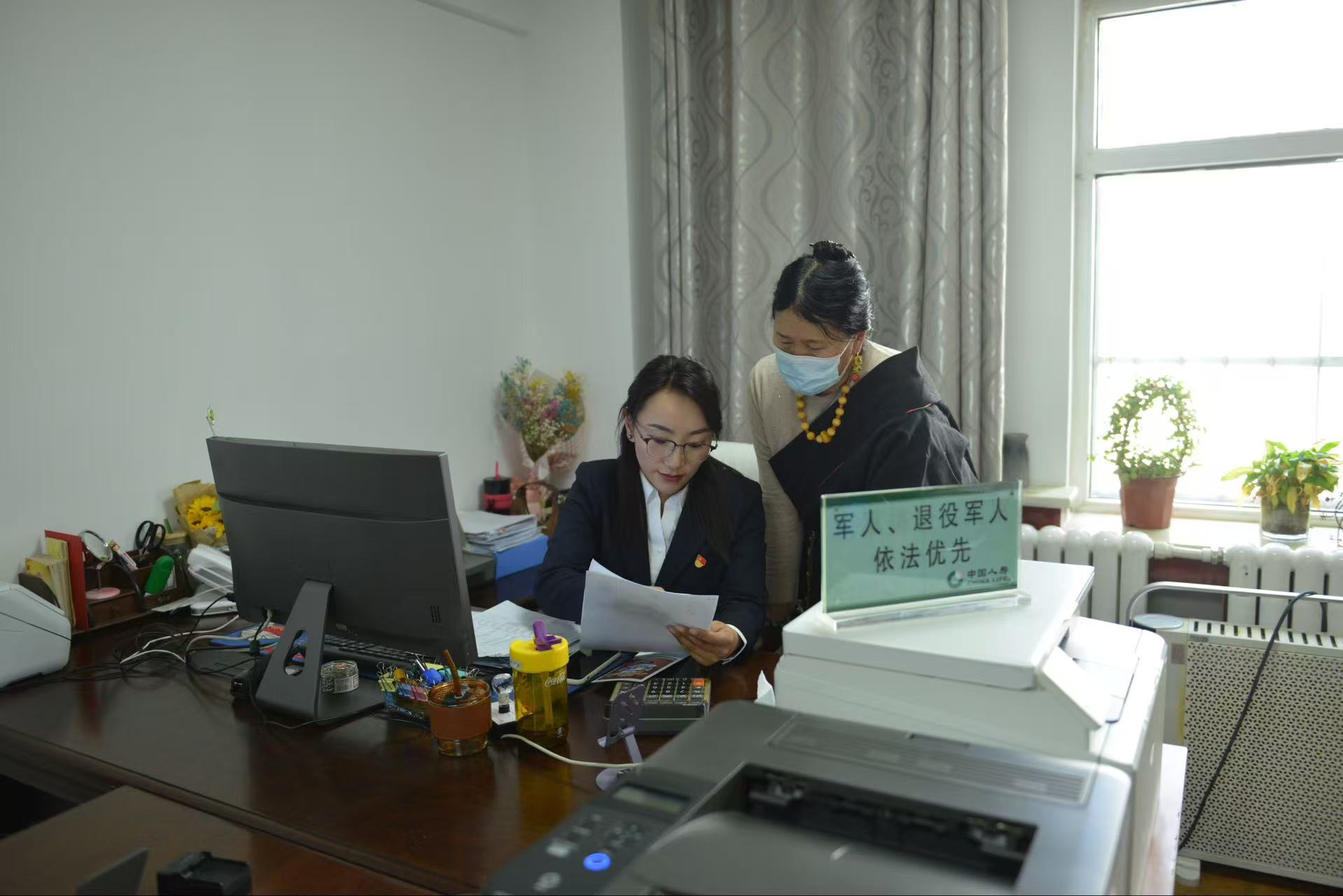 图:工作人员为农牧民介绍“青海健康保”