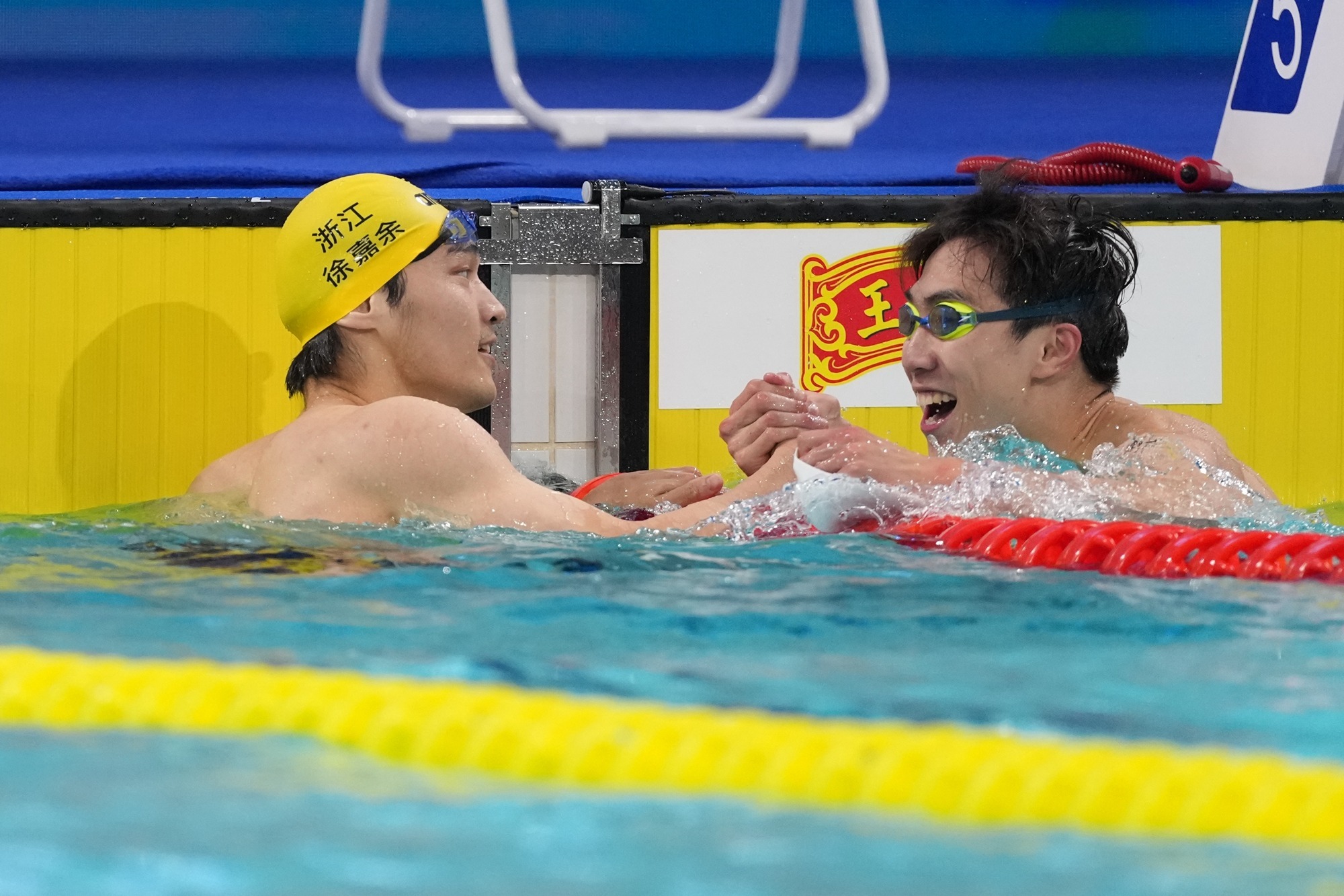 湖北队选手王梓成（右）和浙江队选手徐嘉余在比赛后握手