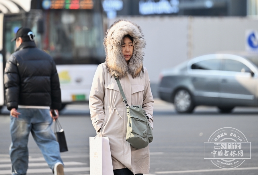 长春气温骤降，街头寒意弥漫。市民纷纷换上厚羽绒服、毛领外套，孩童的卡通保暖帽透着俏皮；路面结起薄冰，落叶覆于冰面，全城开启冬日御寒模式，裹紧衣衫的身影成街头日常。