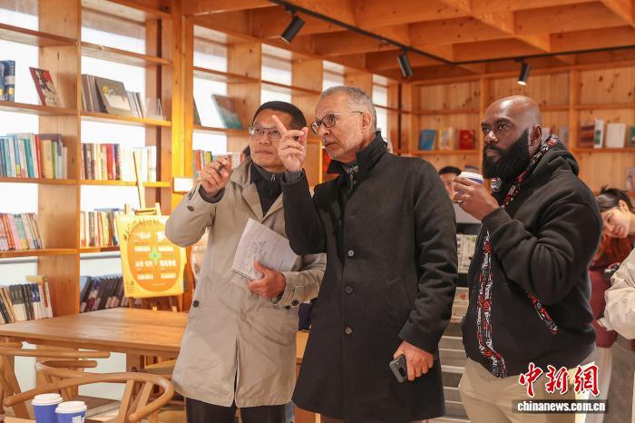 图为中外嘉宾在湖陂村的灵感书屋参观调研。中新社记者 刘力鑫 摄