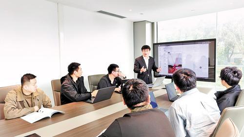 10月15日，河北人工智能计算中心会议室内，数派（廊坊）数据科技有限责任公司总经理张文武（站立者）和技术人员一起讨论正在研发的大模型技术问题。 本报记者刘英摄