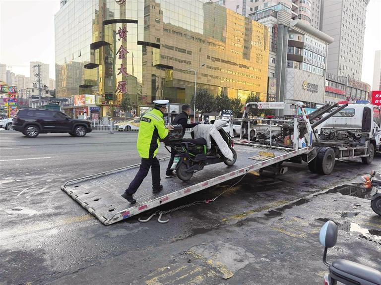 交警整治建兰路商业步行街口乱停放的非机动车