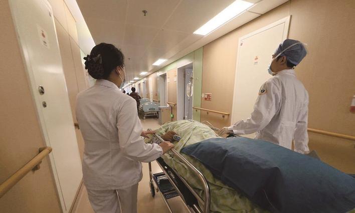 刚做完手术的方秀丽（化名）被医护人员推回病房 通讯员供图