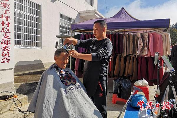 陈立新为村民理发（图片来源：湖南省文明办）