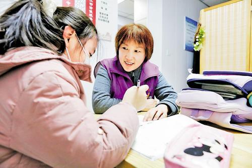 12月3日，在唐山市天云社会工作服务中心，“爱心妈妈”武乐娜（右）正在辅导“女儿”写作业。本组图片由本报记者师源摄