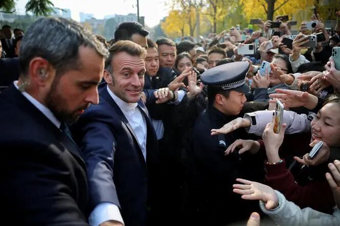 French President Emmanuel Macron greets students during a visit to the Sichuan University in Chengdu, Sichuan province, as part of a three-day visit to China, December 5, 2025.