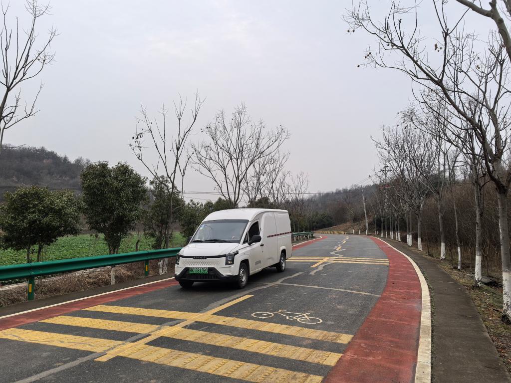 一辆新能源汽车行驶在孝昌县农村公路上。新华社记者 田中全 摄