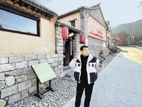 1月1日，在阜平县骆驼湾村，村民白龙正用手机直播，介绍村里的情况。 本报见习记者 李靖恬摄