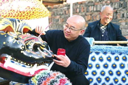 王维鹏（前）和杨民杰制作彩绘兽头、麒麟兽身，两人在协作中赋予道具鲜活神韵。