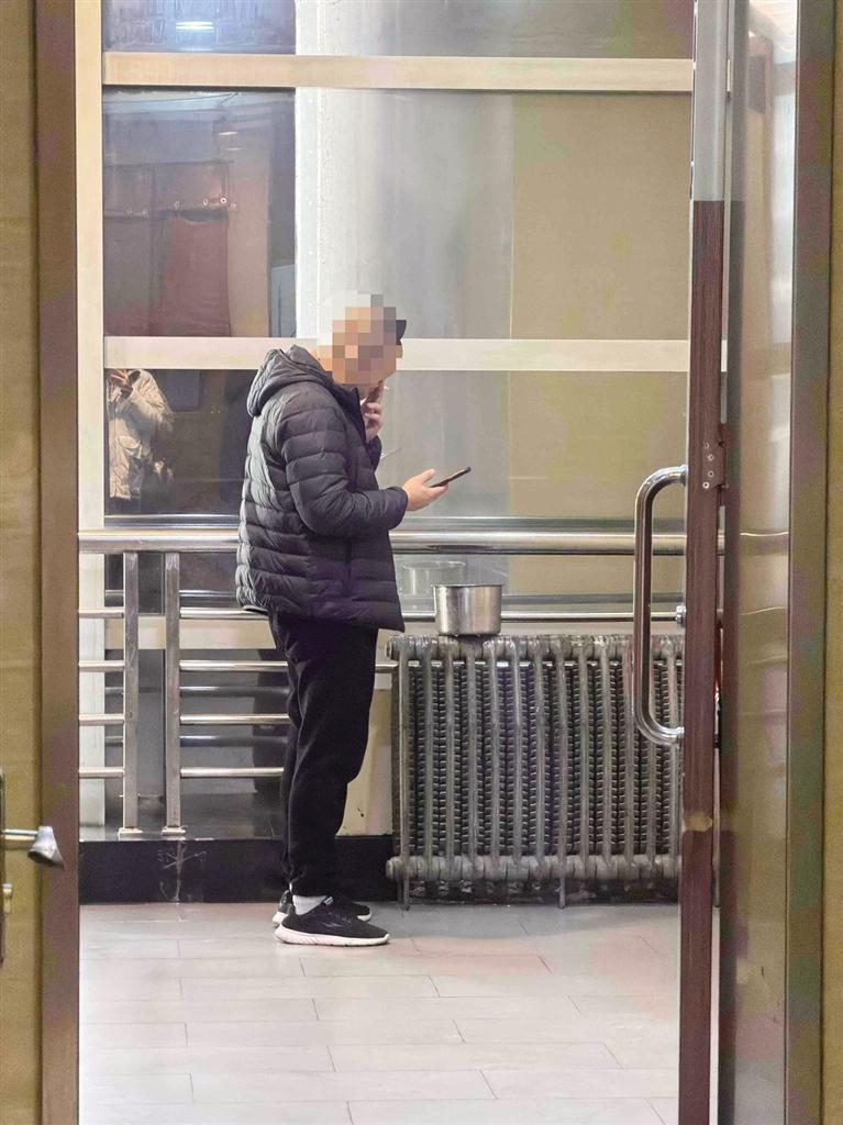 一男士在商场厕所内吞云吐雾