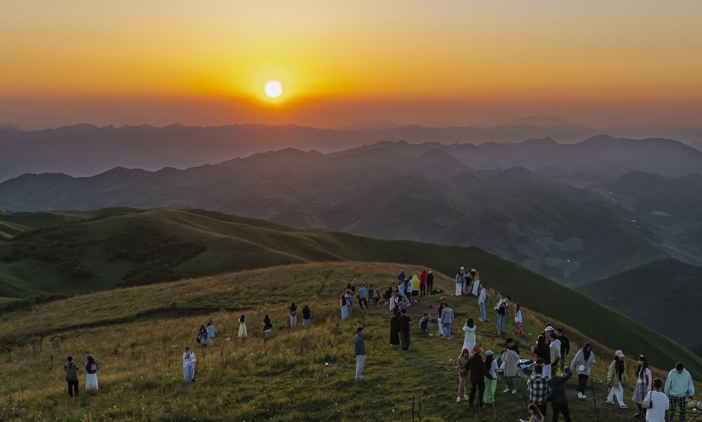 2025年7月30日,在甘肃省陇南市武都区千坝牧场,游人在观赏日出。冉创昌 摄