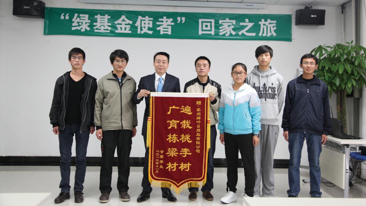 ▲2013年,受绿基金捐助的甘肃学生向徐建成赠送锦旗