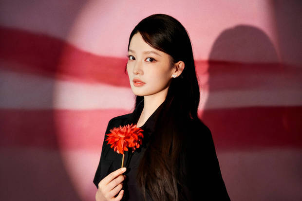 李沁立于粉红光影间，氛围感十足。