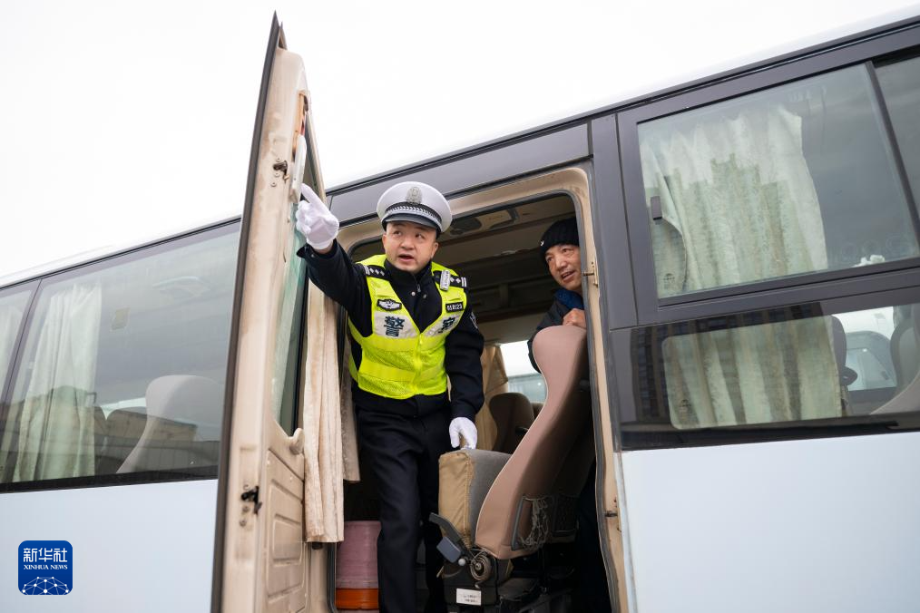 1月29日,在湖北省武汉市宏基长途客运汽车站,武汉交警对长途汽车进行安全检查。新华社记者 伍志尊 摄