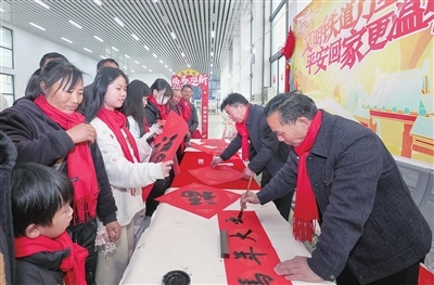 图为1月31日，在萍乡火车站，书法家为旅客书写春联。