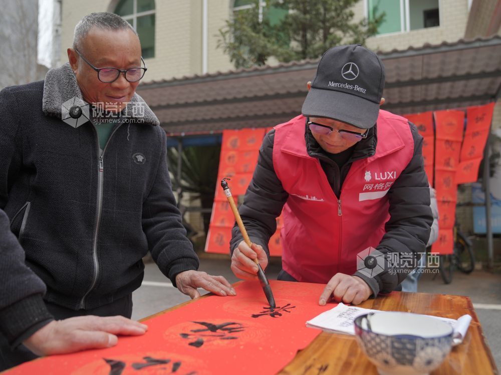 2026年2月4日,在江西省萍乡市芦溪县芦溪镇更田村,党员志愿者和书法爱好者为村民写春联。