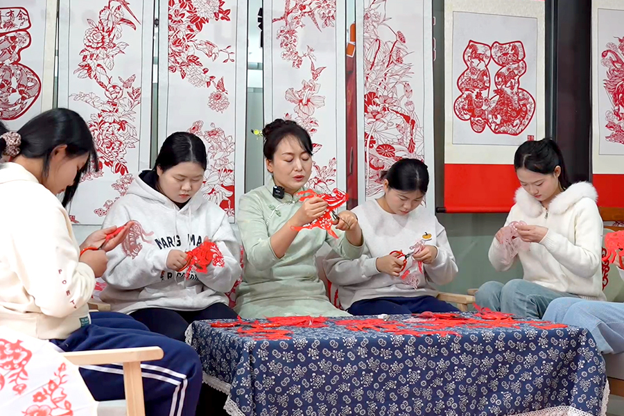 1月28日，冠县剪纸手工艺人刘俊华（左三）带领学生，进行马年主题剪纸创作。任焕珍 王冉 摄