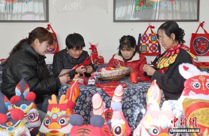 图为庆阳市沁轩文化传媒有限公司绣娘绣制香包 盘小美 摄