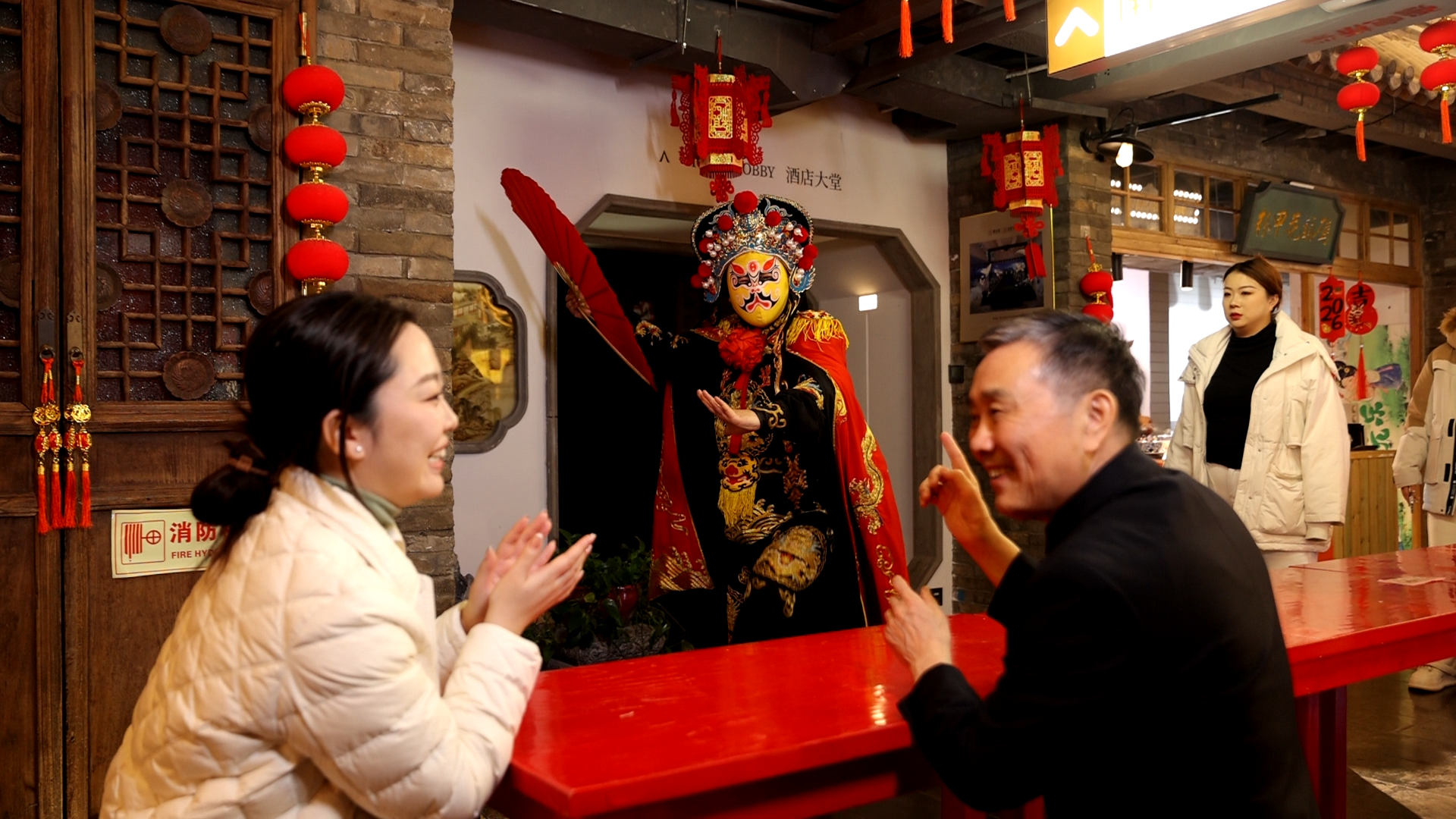 2月7日，梁连起（右）带着记者一起沉浸式观看互动表演。张灵/摄