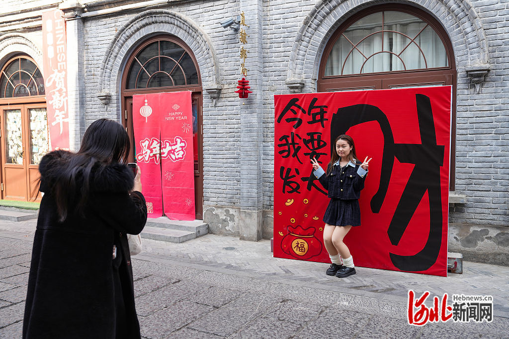 2月14日，游客在保定西大街打卡拍照。
