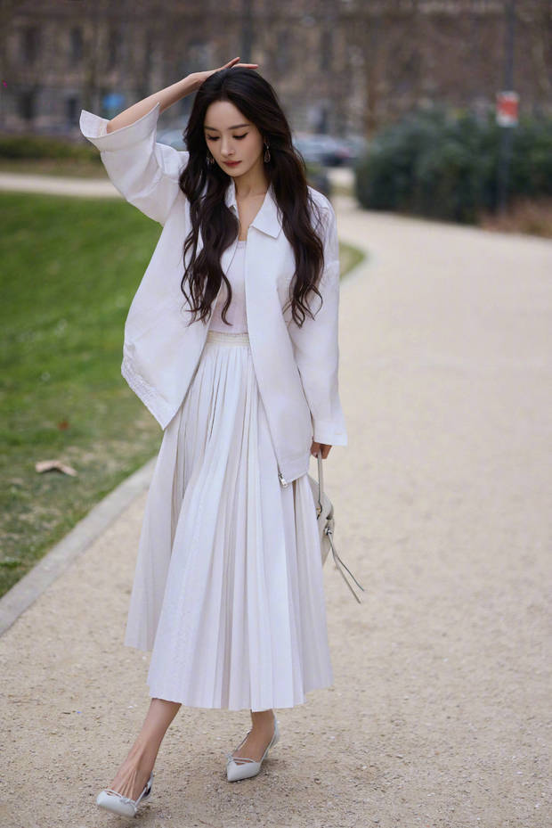 搜狐娱乐讯 2月26日，杨幂一袭白裙现身米兰时装周，照片里的她长发微卷，散发浓浓的浪漫风情。