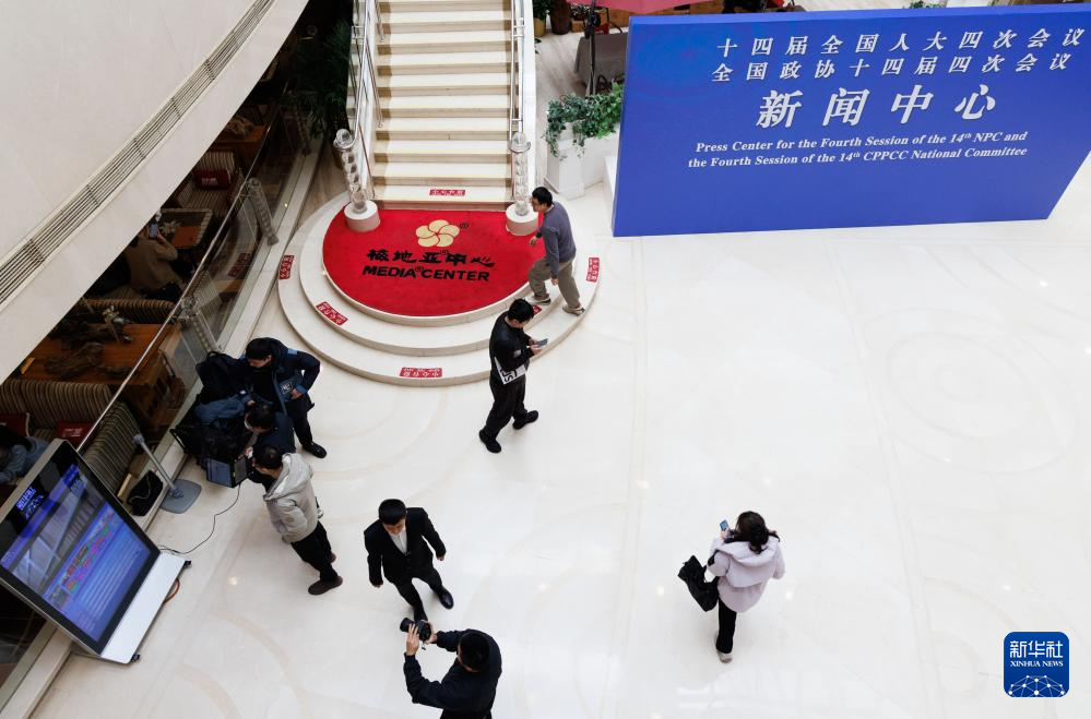 2月27日,媒体记者和工作人员在全国两会新闻中心忙碌。新华社记者 金立旺 摄