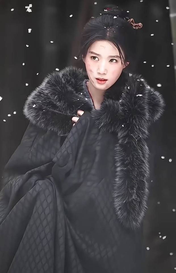 卢昱晓裹紧黑斗篷抬眸，眼神倔强又破碎。