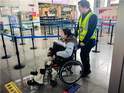 景德镇机场”窑火红“志愿者帮助行动不便的旅客进站。 （特约通讯员 雷乐其 摄）