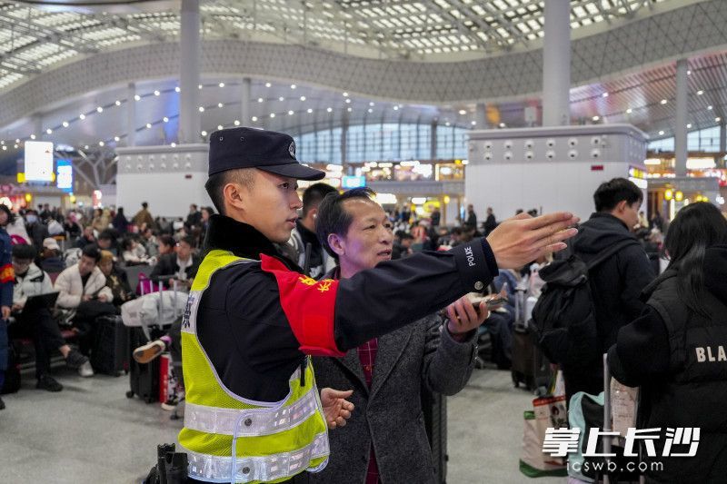 执勤警力为旅客提供指引。通讯员 张威 摄