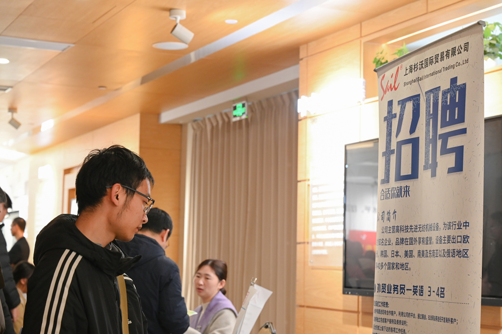 2026年3月7日,中小企业招聘会现场,一位求职者正在读企业招聘上的介绍。澎湃新闻记者 吴栋 图
