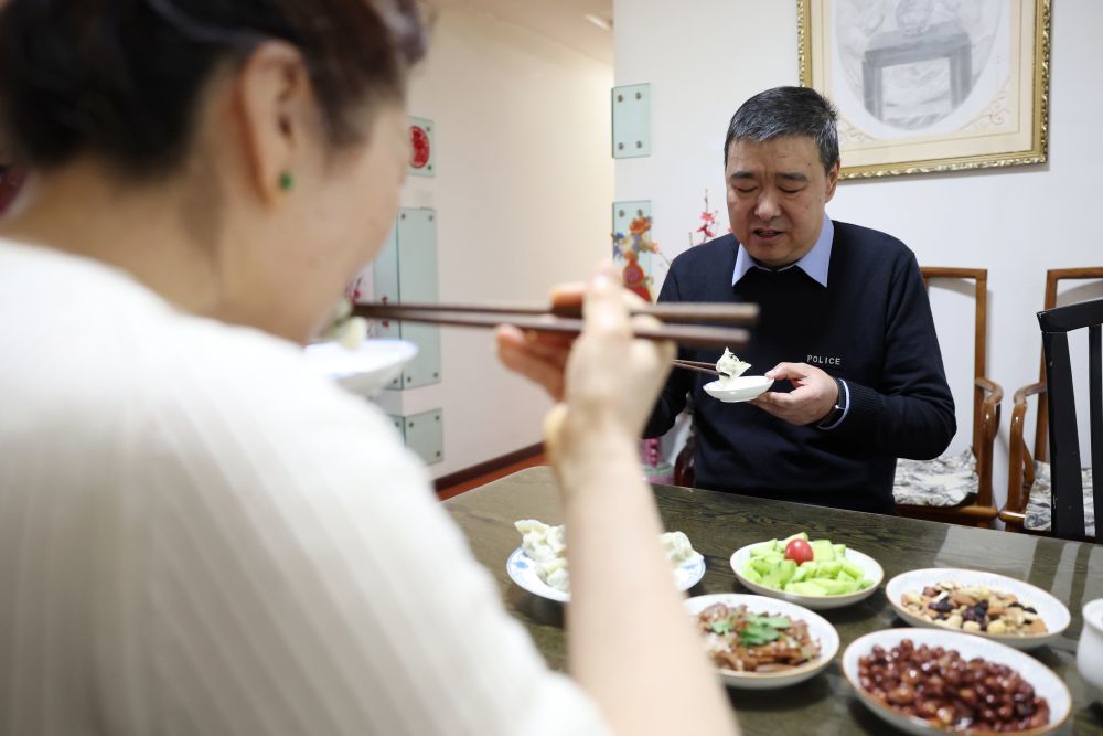 3月11日，兰州铁路公安处乘警支队民警段文革（右）在最后一次值乘前与妻子王春兰在家里吃饺子。新华社记者　陈斌　摄