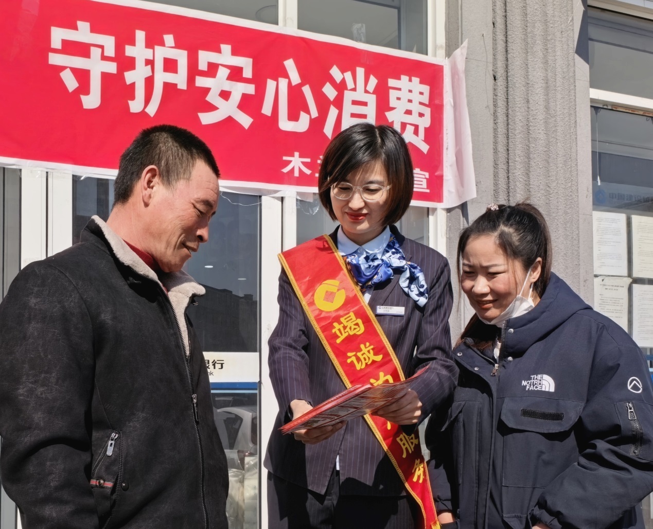 （建设银行木兰支行在网点门前设置咨询台，向过住群众宣传消保知识）