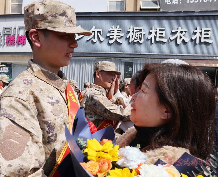 亲属向即将踏进军营的新兵赠送鲜花，以表深情嘱托和厚望。